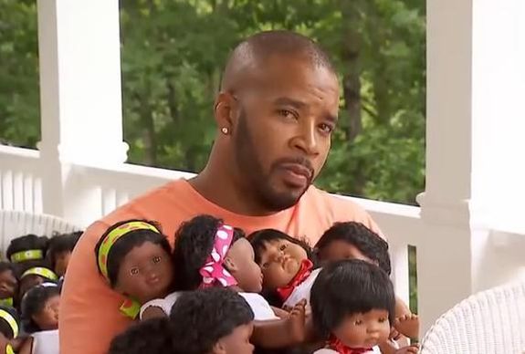 "I may be holding a bunch of baby dolls, but I'm still tough."