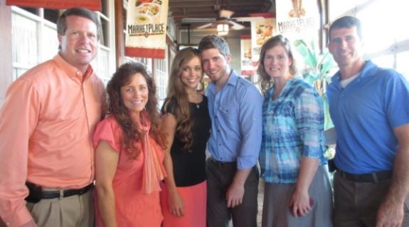 Guinn and Michael Seewald (far right) are standing with the Duggars.