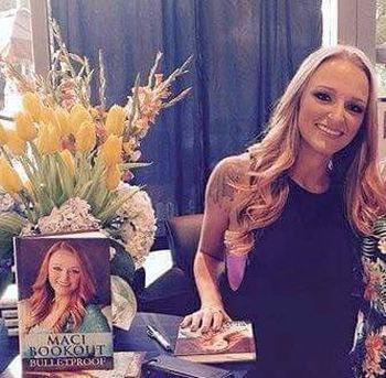 Maci and her book at her recent signing in Nashville. 