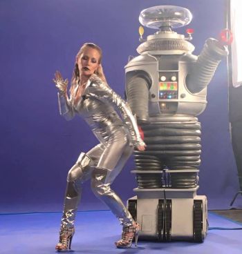 For some reason, Kendra hired Screech's robot from Saved by the Bell to be in her video...